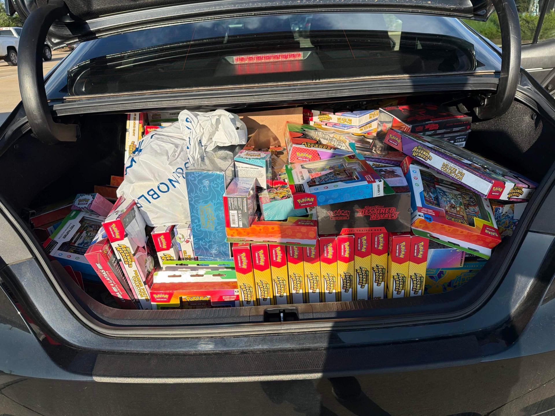 Car trunk packed with Pokemon TCG products