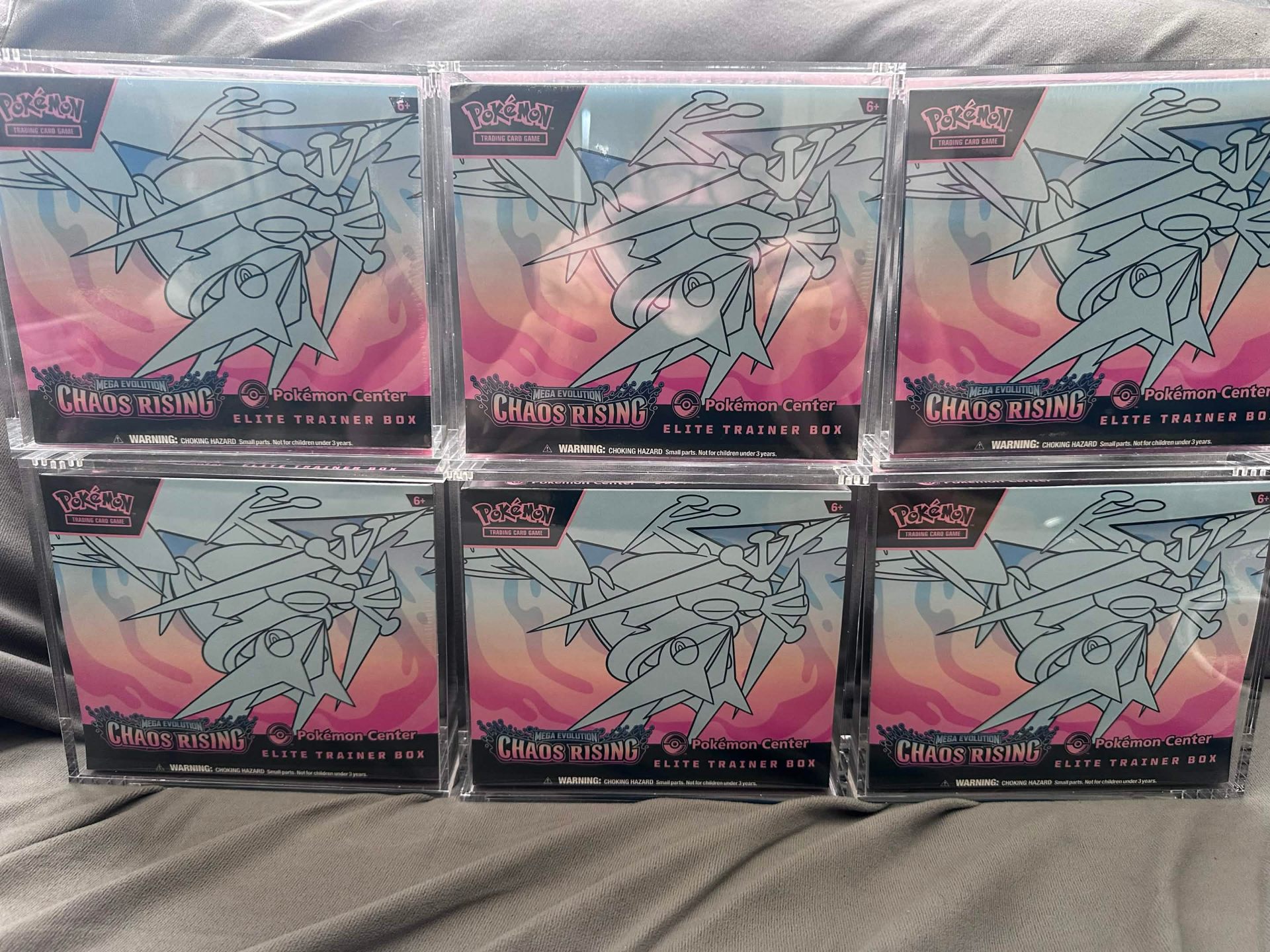 Six Chaos Rising Elite Trainer Boxes in protective cases